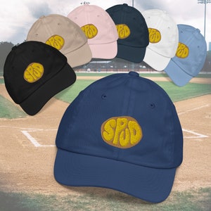 May include: A collection of baseball caps in various colors, each featuring a yellow embroidered logo that says "SPUD".