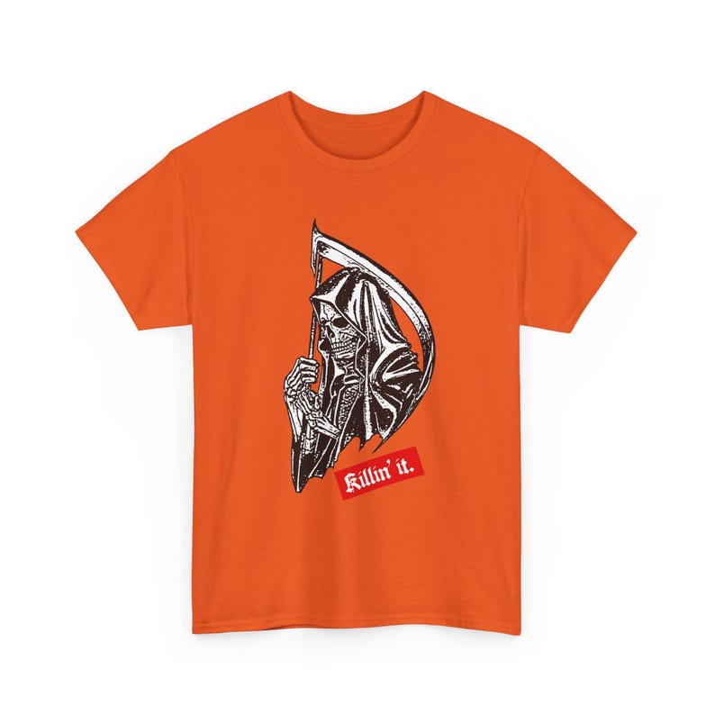 An orange short-sleeve t-shirt featuring a black and white graphic of a grim reaper holding a scythe, with a red rectangular patch below containing the white text Killin it.