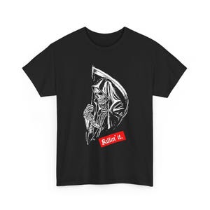 A plain black t-shirt laid flat, featuring a graphic of a hooded grim reaper holding a scythe and red text.