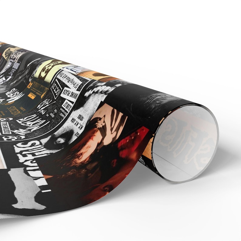 A roll of black and white Misfits-themed wrapping paper, partially unrolled to show the collage design.