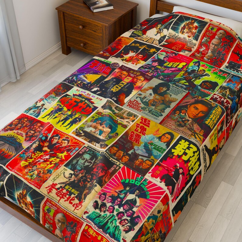 A blanket patterned with a collage of vintage Kung Fu movie posters covers a bed with a wooden headboard.