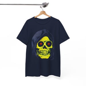 A navy blue t-shirt with a yellow skull in a blue hood hangs on a wooden hanger against a white background.