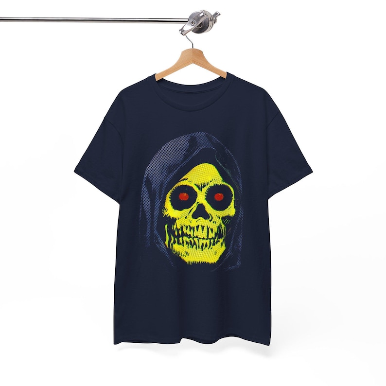 A navy blue t-shirt with a yellow skull in a blue hood hangs on a wooden hanger against a white background.