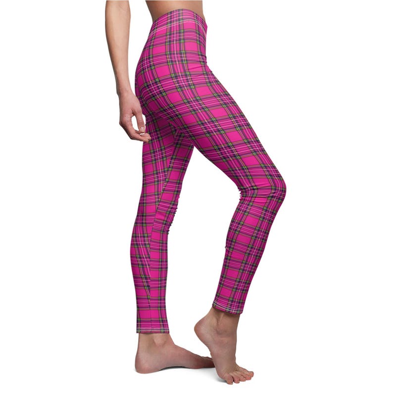 Side view of a person wearing bright pink and black plaid print leggings.