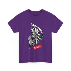 A purple short-sleeve t-shirt displaying a black and white illustration of the grim reaper with a scythe and a red banner underneath with white text that reads Killin it.