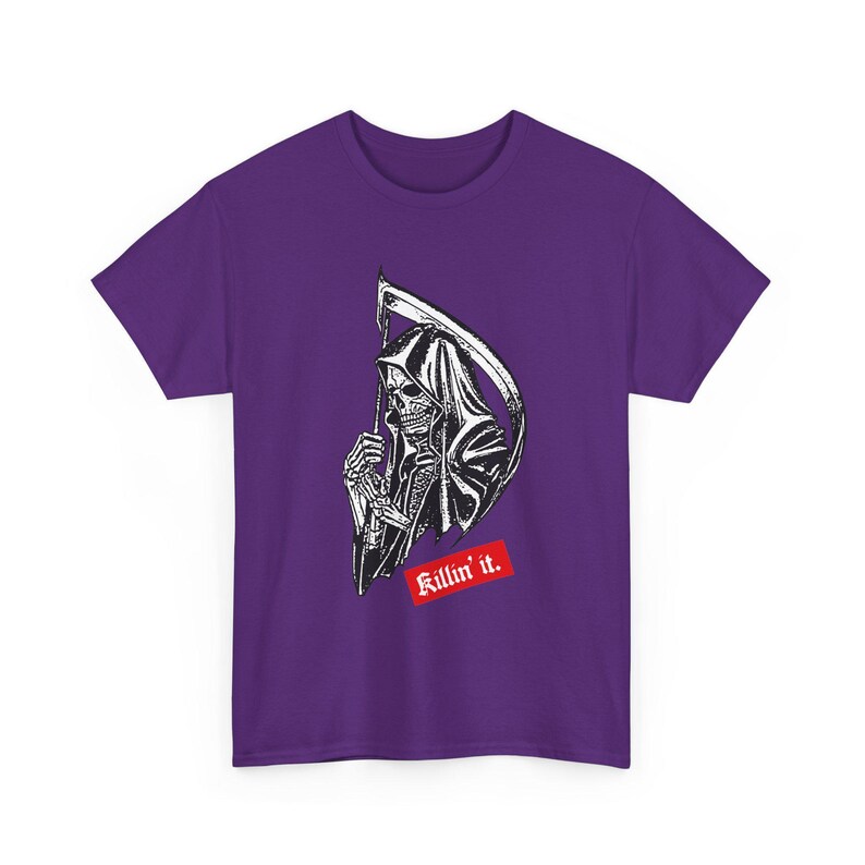 A purple short-sleeve t-shirt displaying a black and white illustration of the grim reaper with a scythe and a red banner underneath with white text that reads Killin it.