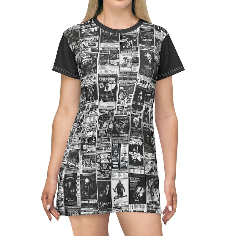 A close-up shot of the front of a t-shirt dress featuring a black-and-white collage of vintage horror film posters and solid black short sleeves.