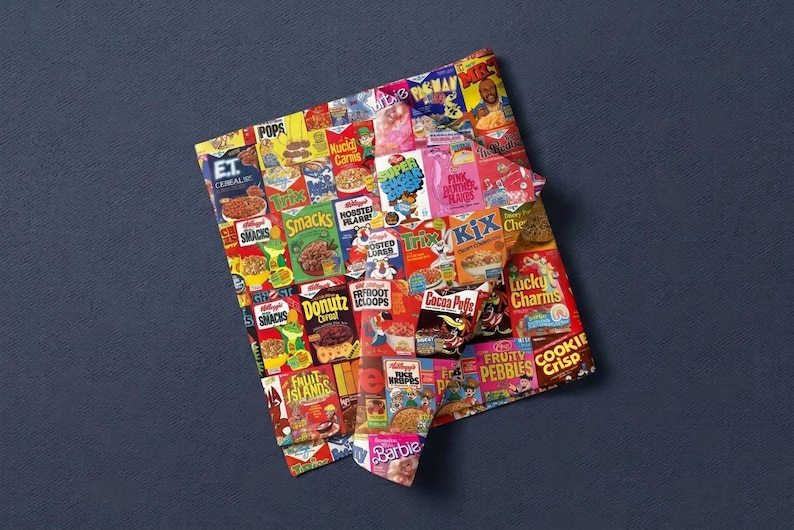 May include: A square sheet of wrapping paper featuring a colorful collage of vintage cereal box logos and character graphics, including E.T., Trix, Lucky Charms, Cocoa Puffs, Pac-Man, Barbie, and various other breakfast food brand designs.