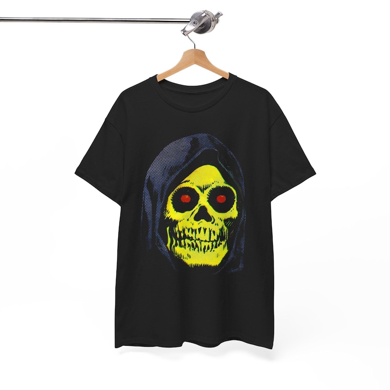 A black t-shirt with a yellow skull in a blue hood hangs on a wooden hanger against a white background.