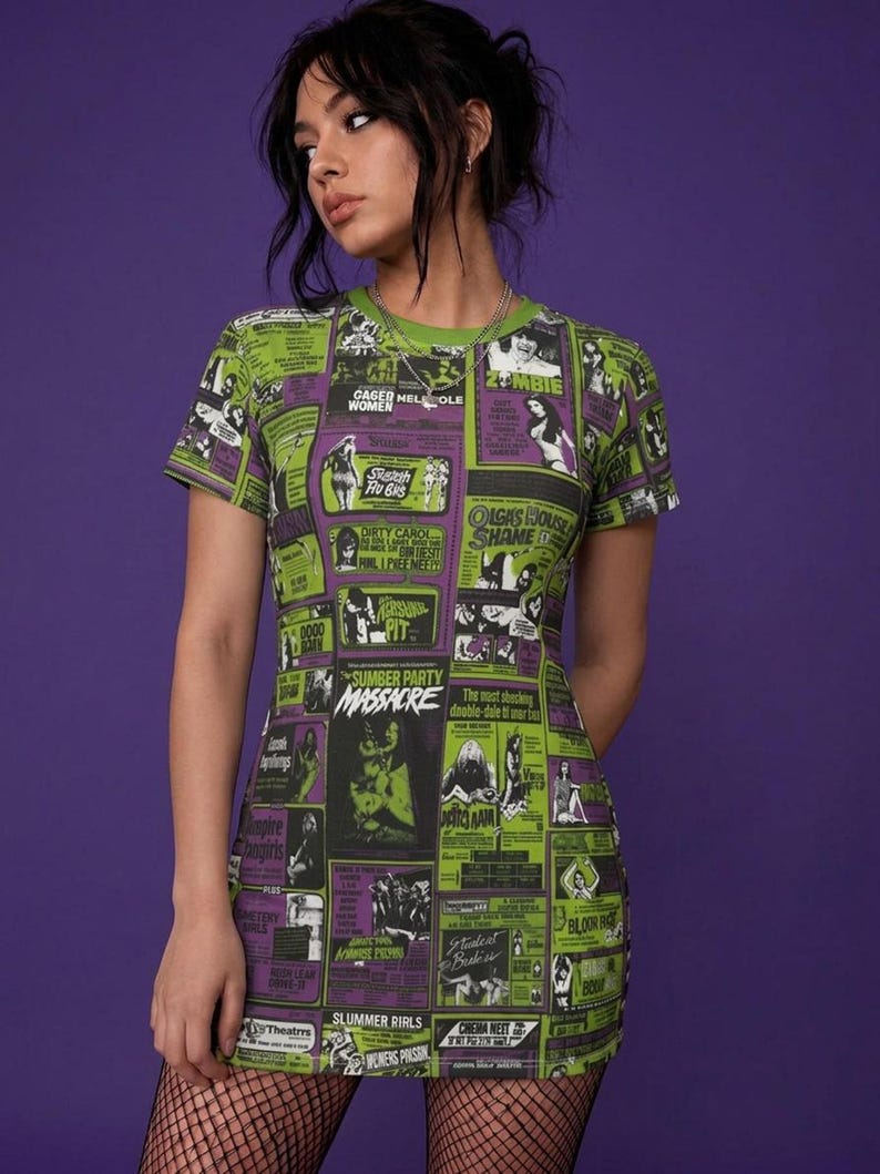 Close-up of a person wearing the horror movie poster t-shirt dress and fishnet stockings against a purple background.