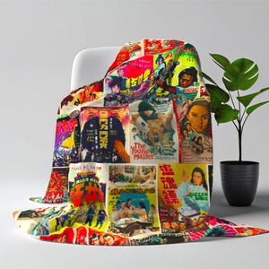 A blanket patterned with a collage of vintage Kung Fu movie posters is draped over a white chair next to a green plant.