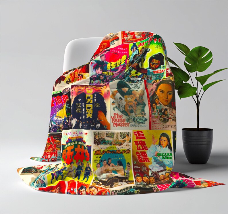 A blanket patterned with a collage of vintage Kung Fu movie posters is draped over a white chair next to a green plant.
