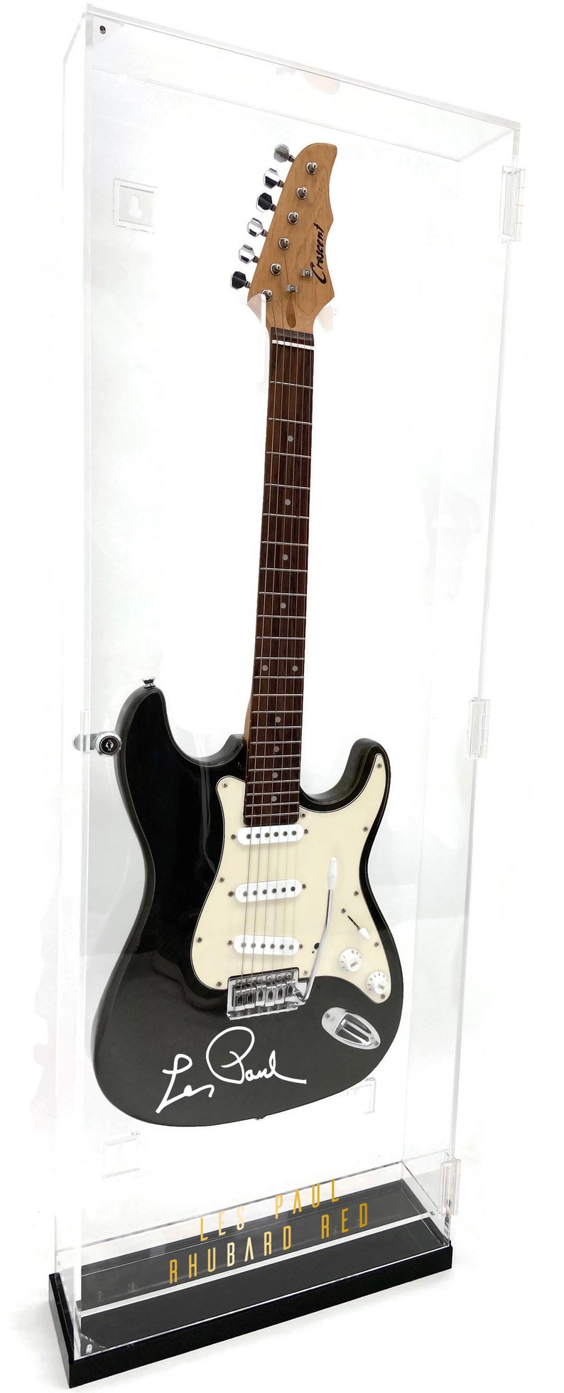 May include: Black electric guitar in a clear display case. The guitar has a white pickguard, chrome hardware, and the signature "Les Paul". The case base reads "Les Paul Rhubard Red".