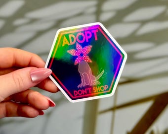 Pegatina "Adopta, no compres" de Demodog • Regalo de criatura de terror fantástico para amantes de los animales