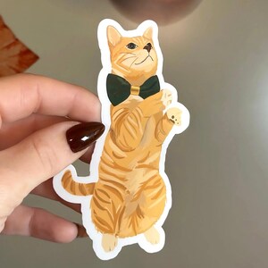 Bonita pegatina navideña de gato naranja con pajarita: pegatina de regalo navideño para amantes de los gatos, planificador, calcomanía festiva para computadora portátil, idea para rellenar calcetines