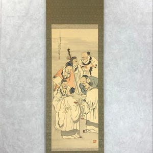 May include: A traditional Asian scroll painting featuring a group of figures in robes, possibly scholars or officials. The artwork is rendered in muted tones with a focus on the figures and their interactions. The scroll has a decorative border.