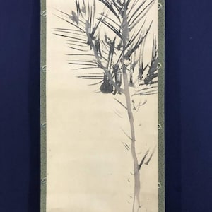 May include: A vertical scroll painting showing a minimalist tree branch design. The artwork uses black ink brushstrokes on a cream background. The scroll is framed with a green border and set against a dark blue backdrop.