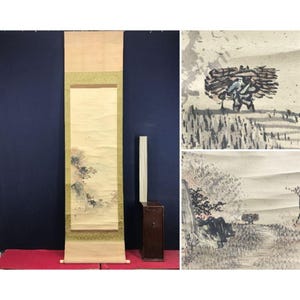 May include: An antique Japanese scroll painting depicting a landscape with mountains and trees. The scroll is displayed vertically, with a cream background and a green border. Additional ink wash landscape paintings are also shown.