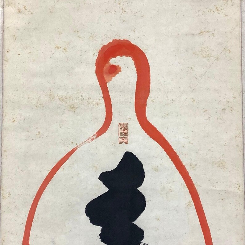 May include: Abstract artwork featuring a red outline and a black shape on a cream-colored background. The red outline resembles a bottle shape, with a small red stamp near the top. The black shape is a stylized form.