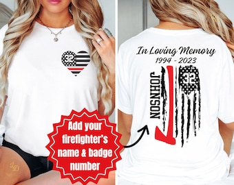 May include: White t-shirt with a red heart with a thin red line American flag design and the number 32 on the front. The back of the shirt has a black and white American flag design with a red axe and the text "In Loving Memory 1994-2023 JOHNSON 32".