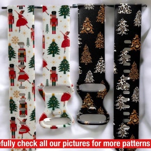 May include: Four different patterned watch bands. The bands are white with a nutcracker and Christmas tree design, black with a leopard print and Christmas tree design, and black with a Christmas tree design. The bands are made of silicone and have a buckle closure.