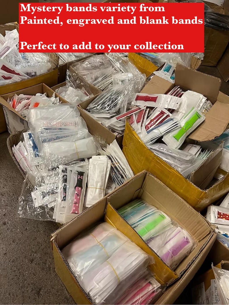 May include: A variety of watch bands in different colors and patterns, including painted, engraved, and blank bands. The bands are packaged in individual plastic bags and are arranged in boxes. The text "Mystery bands variety from Painted, engraved and blank bands Perfect to add to your collection" is visible at the top of the image.