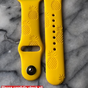 May include: Two yellow silicone Apple Watch bands with a pineapple pattern. The bands are designed to fit a 40mm or 44mm Apple Watch.