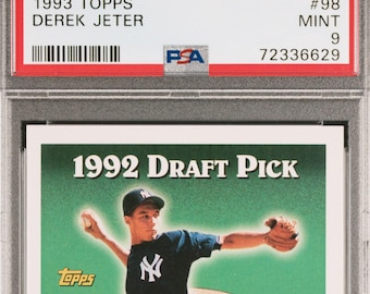 May include: A 1993 Topps baseball card featuring Derek Jeter in a New York Yankees uniform. The card is a 1992 Draft Pick card and is graded PSA 9 Mint.