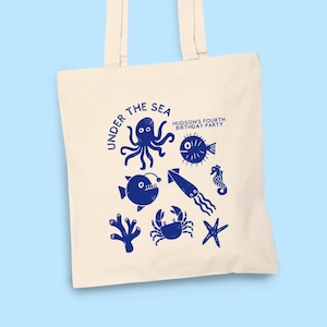 May include: A set of three ceramic mugs with a speckled, matte finish. The mugs are in shades of cream, light gray, and dark gray. Each mug has a simple, minimalist design, perfect for coffee or tea.