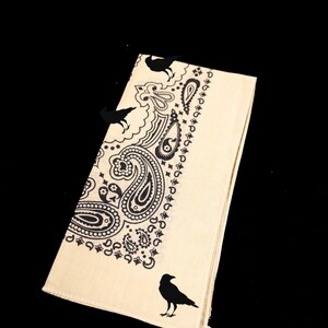 May include: A beige bandana with a black paisley pattern and black crow silhouettes.