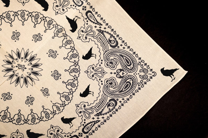 May include: A beige bandana with a black paisley pattern and black crow silhouettes.