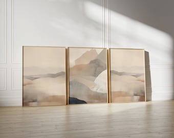Peut inclure: Trois tableaux abstraits de paysages encadrés avec une palette de couleurs douces de beige, brun et gris. Les tableaux sont disposés en rangée sur un sol en bois clair.
