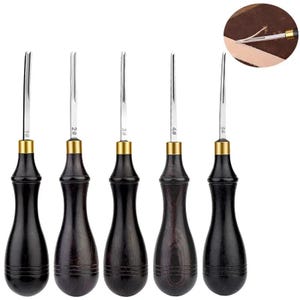 May include: Set of five leathercraft tools with dark wood handles and silver blades. Each tool is numbered from 1 to 5, with a gold-colored band at the base of the blade. The tools are designed for leatherworking and crafting.