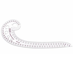 May include: A clear, plastic sewing curve ruler with a curved shape and a straight edge. The ruler has measurements in inches and features several circular cutouts. The text "MADE IN CHINA" is visible.