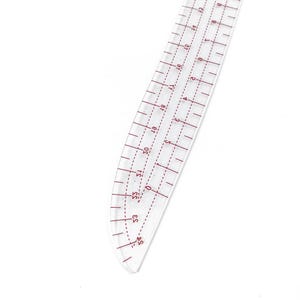 May include: A clear, curved ruler with red markings and numbers. The ruler is designed for sewing and pattern making, featuring measurements in inches and a curved edge for shaping. The ruler is made of transparent plastic.