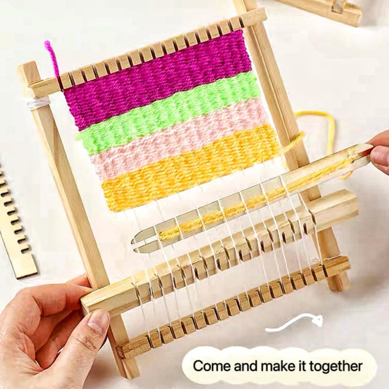 May include: A wooden weaving loom with colorful yarn in shades of pink, green, and yellow. The loom is partially woven, showing the process of creating a textile. The text "Come and make it together" is visible.