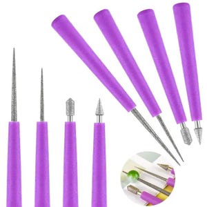 May include: A set of diamond burr drill bits featuring purple handles and various abrasive tip shapes including needle, cylinder, and cone points. The set includes multiple tools with textured metal tips for precision grinding and drilling tasks.