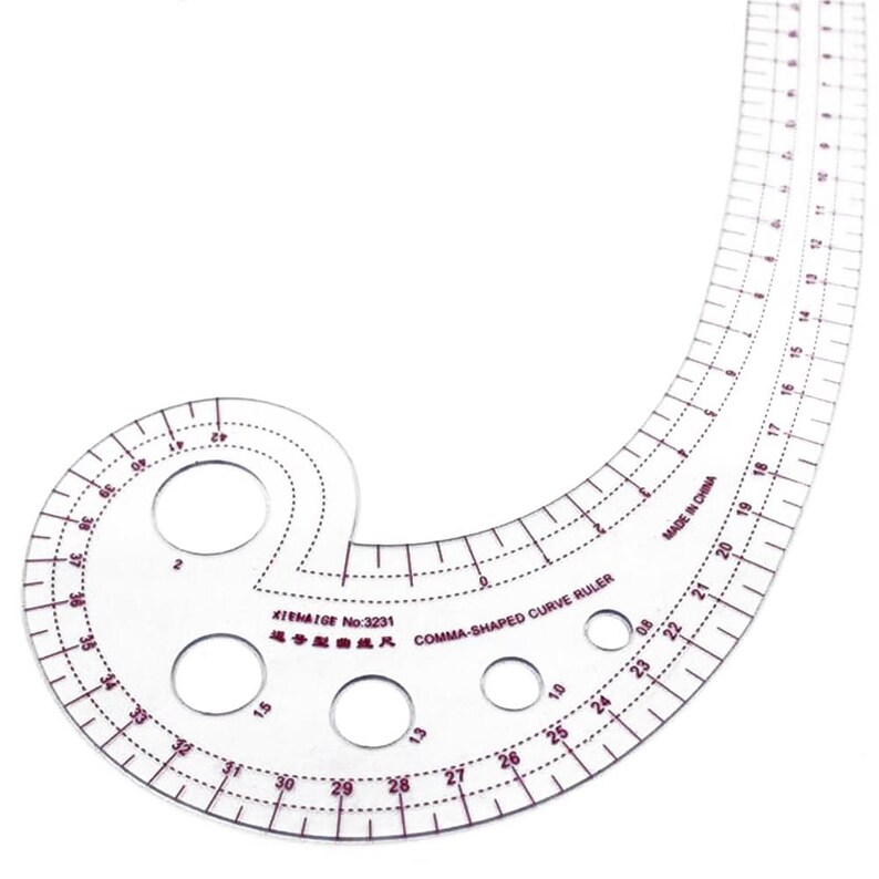 May include: A clear, comma-shaped curve ruler with red markings and circular cutouts. The ruler has measurements in inches and is labeled "KIMATGE No:3231 COMMA-SHAPED CURVE RULER" and "MADE IN CHINA". Ideal for sewing and drafting.
