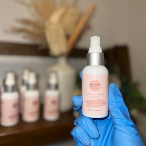 May include: A clear glass bottle with a silver cap and a white label that says "Bikini Body Serum" in pink lettering. The bottle is labeled "Pro Organix" and contains 2 fl oz (59 ml) of serum.