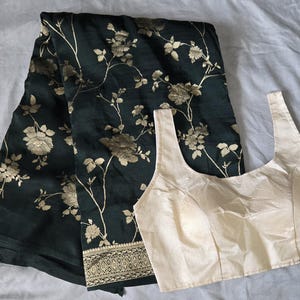 Banarasi georgette saree in bottle green color with floral and creeper design weaving