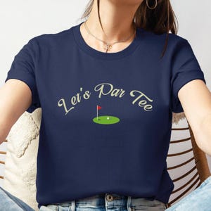 a woman sitting in a chair with a tee shirt on