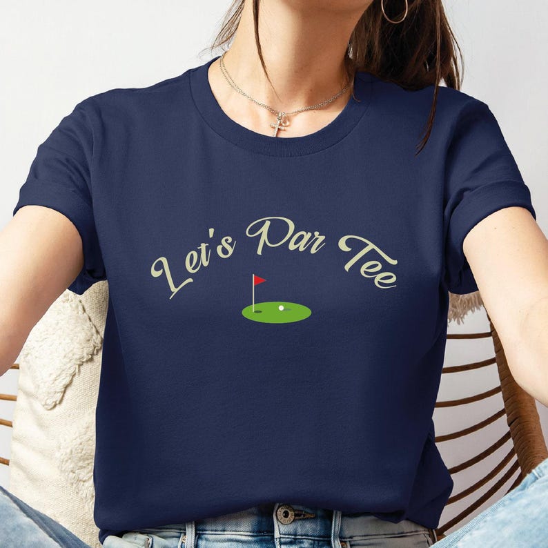 a woman sitting in a chair with a tee shirt on
