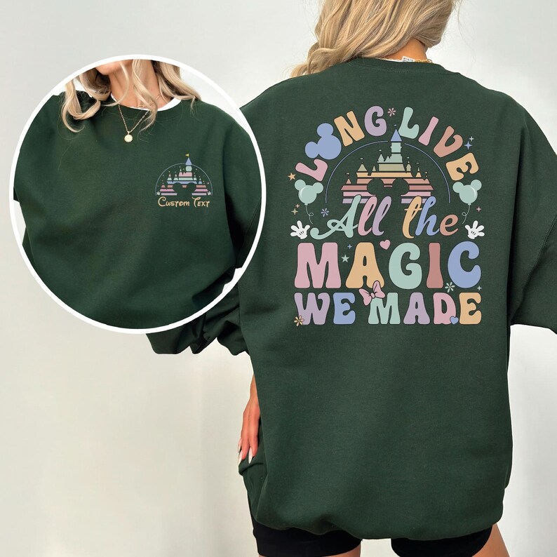 A person wearing a green sweatshirt with a colorful graphic design on the back.