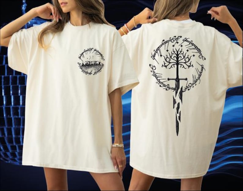 A woman wearing a white t-shirt with a black graphic design on the back, including a tree and a sword.