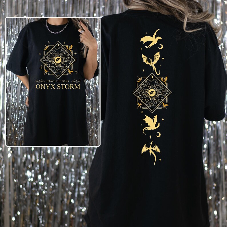 a woman wearing a black shirt with gold designs on it