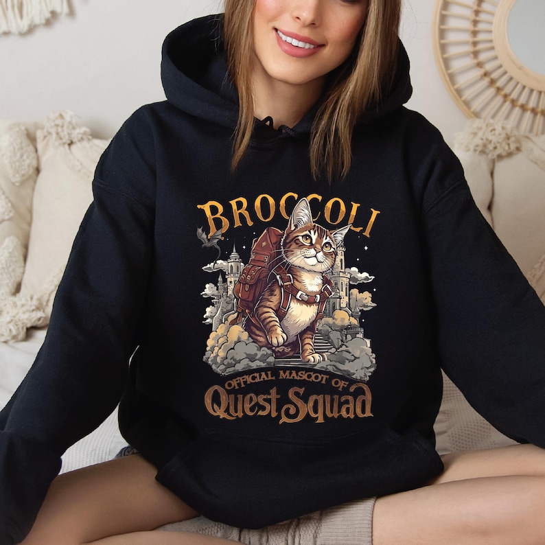a woman sitting on a couch wearing a hoodie