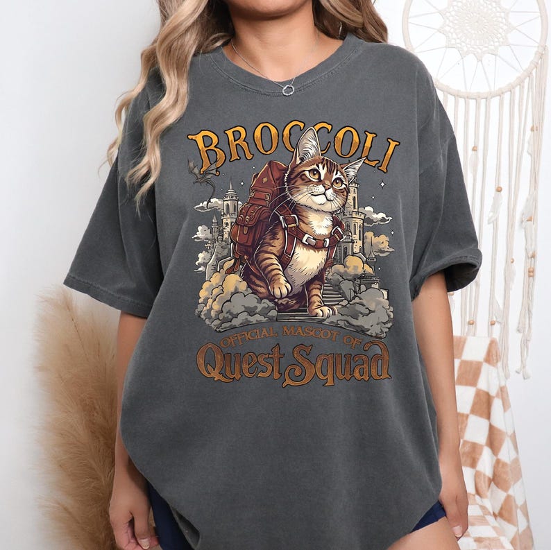 a woman wearing a t - shirt with a picture of a cat on it