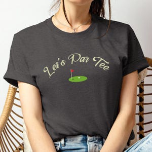 a woman sitting in a chair with a tee shirt on