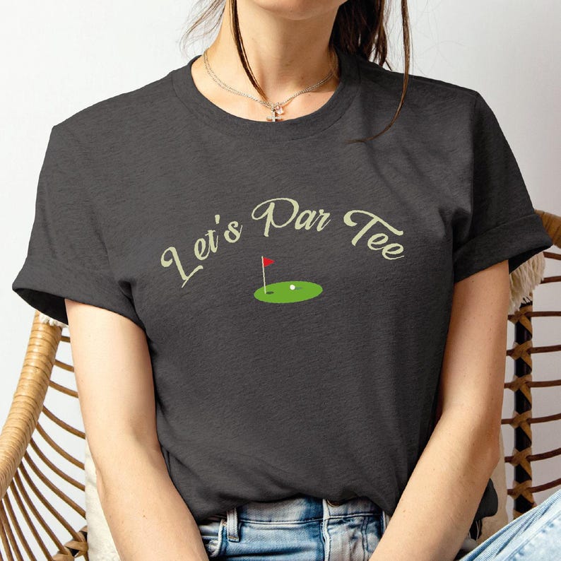 a woman sitting in a chair with a tee shirt on