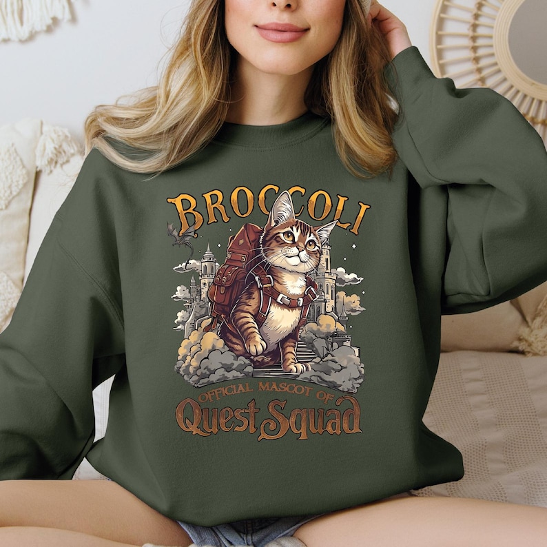 a woman wearing a green sweatshirt with a cat on it